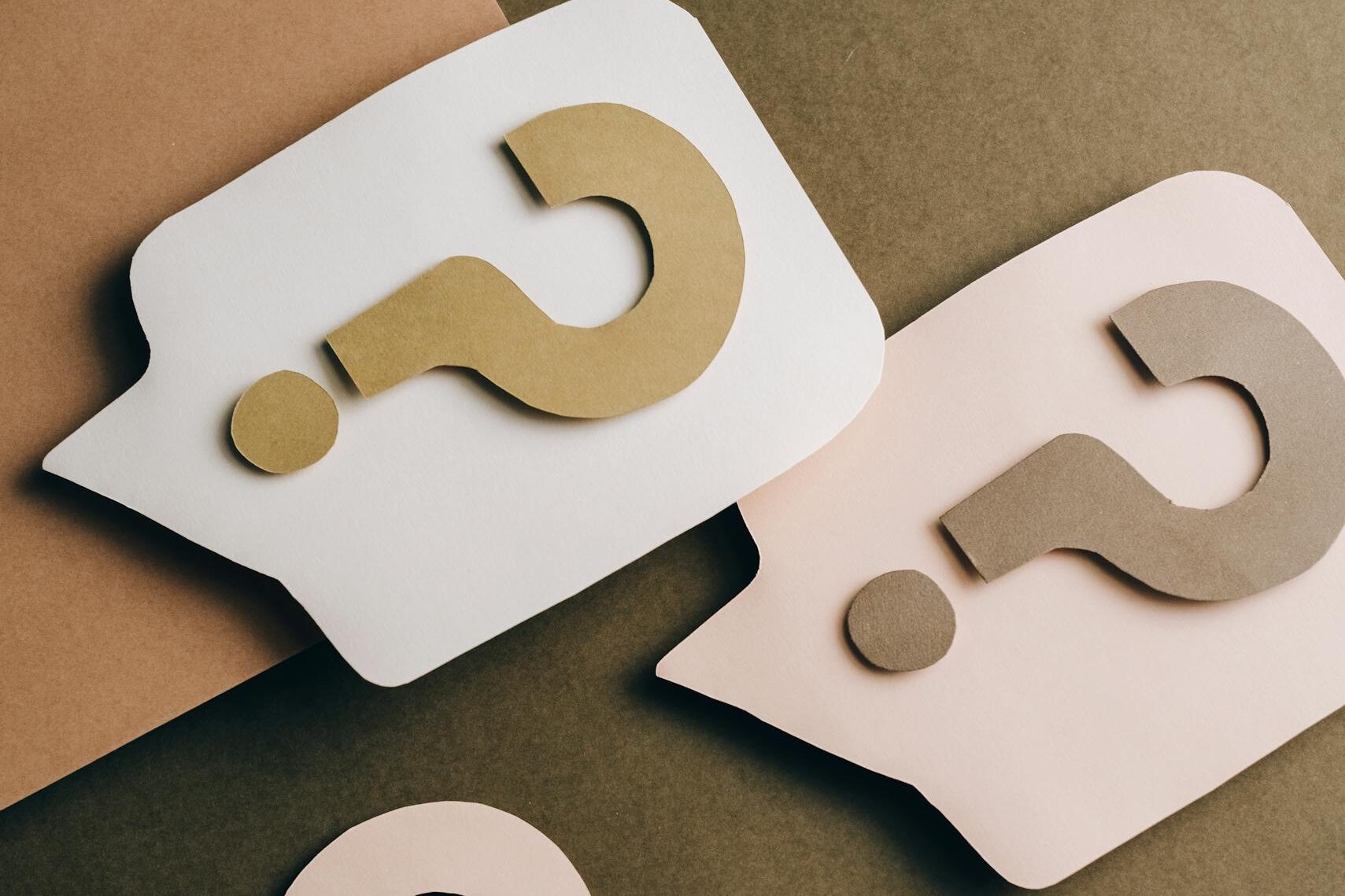 Question Marks on Brown Surface